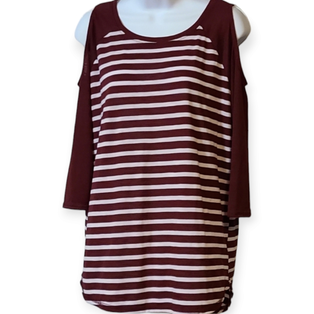 SO woman's striped top with cut out shoulder.